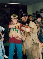 Mike helps a student get the feel of a hand-made bow.